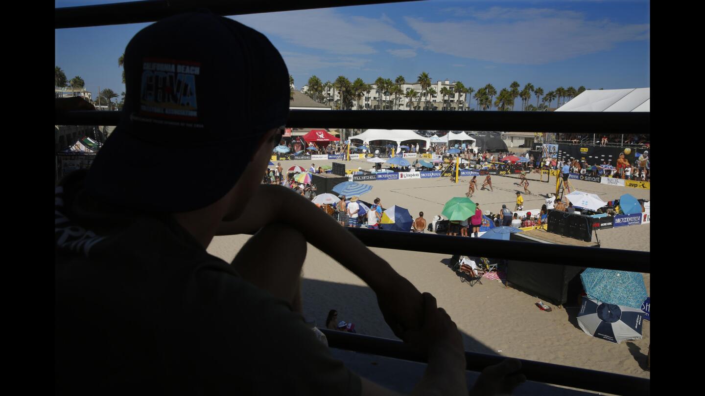 A spectator watches a women's match at the Kingston AVP Championships beach volleyball tournament on Friday in Huntington Beach.