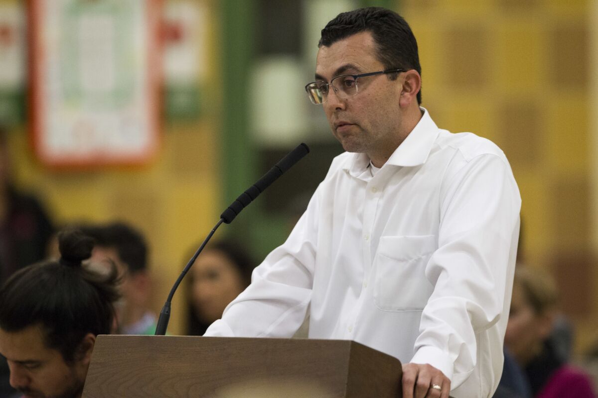 Art Castañares, chief executive of Manzana Energy, speaks to San Ysidro School District trustees at the Feb. 9 board meeting. The district and Castañares have been at odds over completion of a solar power project paid for with Proposition C bond funds.