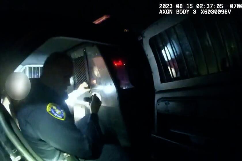 SDPD Handout video stills from file: Former San Diego police Officer Anthony Hair resigned last year after he locked himself in the back seat with a woman who had been arrested.