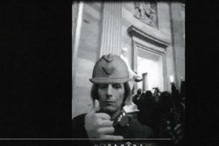 A man investigators say is Philip Weisbecker poses for a photo in the Rotunda of the U.S. Capitol during the Jan. 6 insurrection.