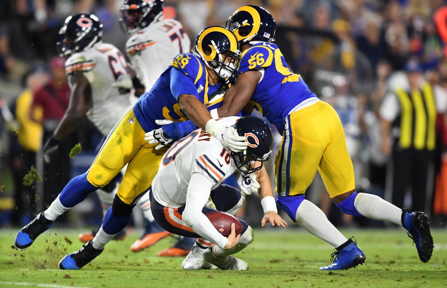 Rams defensive tackle Aaron Donald, left, and defensive end Dante Fowler Jr. bring down Bears quarterback Mitchell Trubisky.