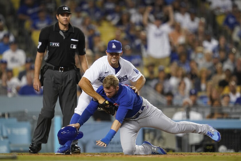Dodgers pitcher Tyler Anderson flags down Chicago Cubs outfielder Ian Happ during a game July 8, 2022 at Dodger Stadium.