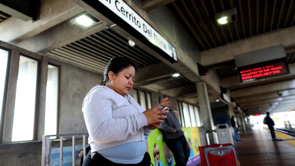 Veronica Aguilar, of El Salvador, waits to board a BART train in Pinole.