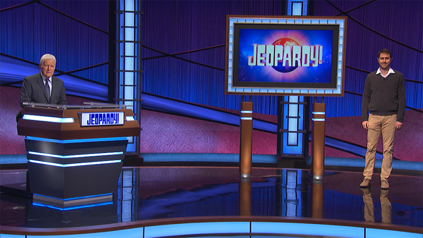 Costa Mesa resident Ben Lewis stands on the set of "Jeopardy!" along with host Alex Trebek. 