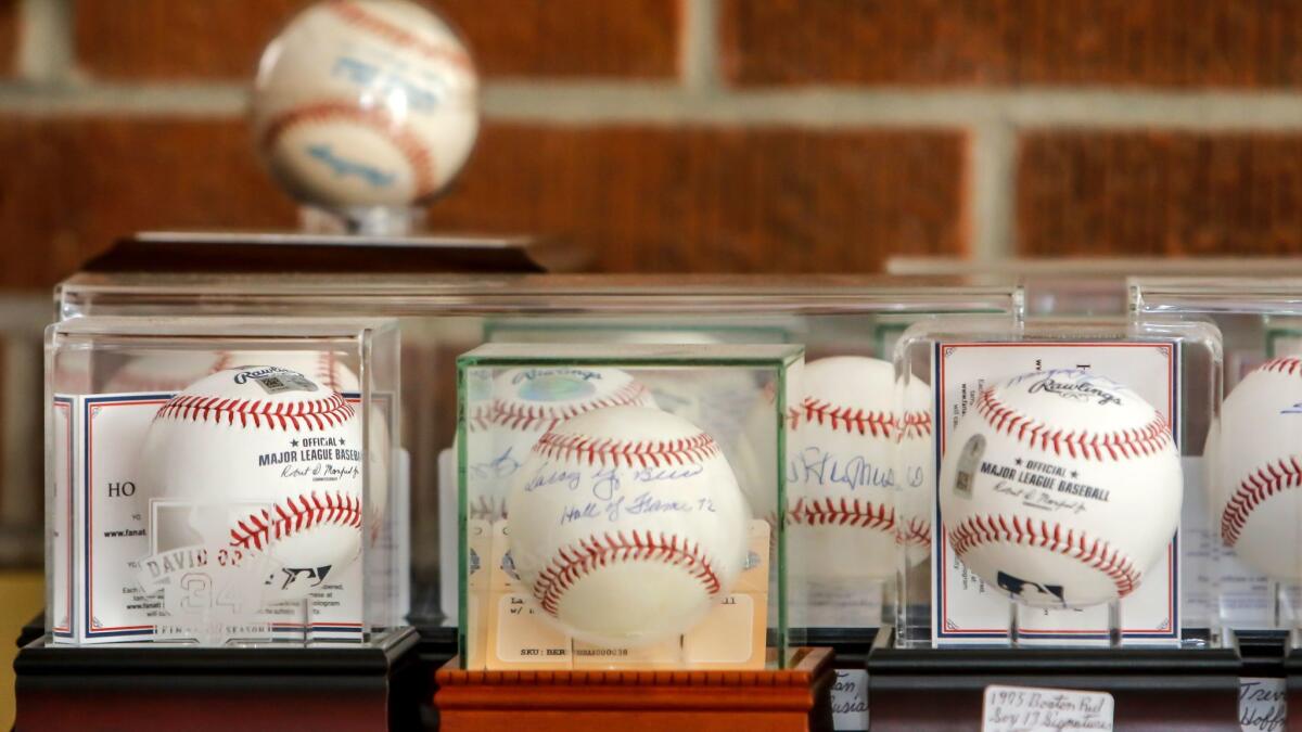 Some of the autographed baseballs that Jeffrey D. Olsen donated to the Armed Forces YMCA.