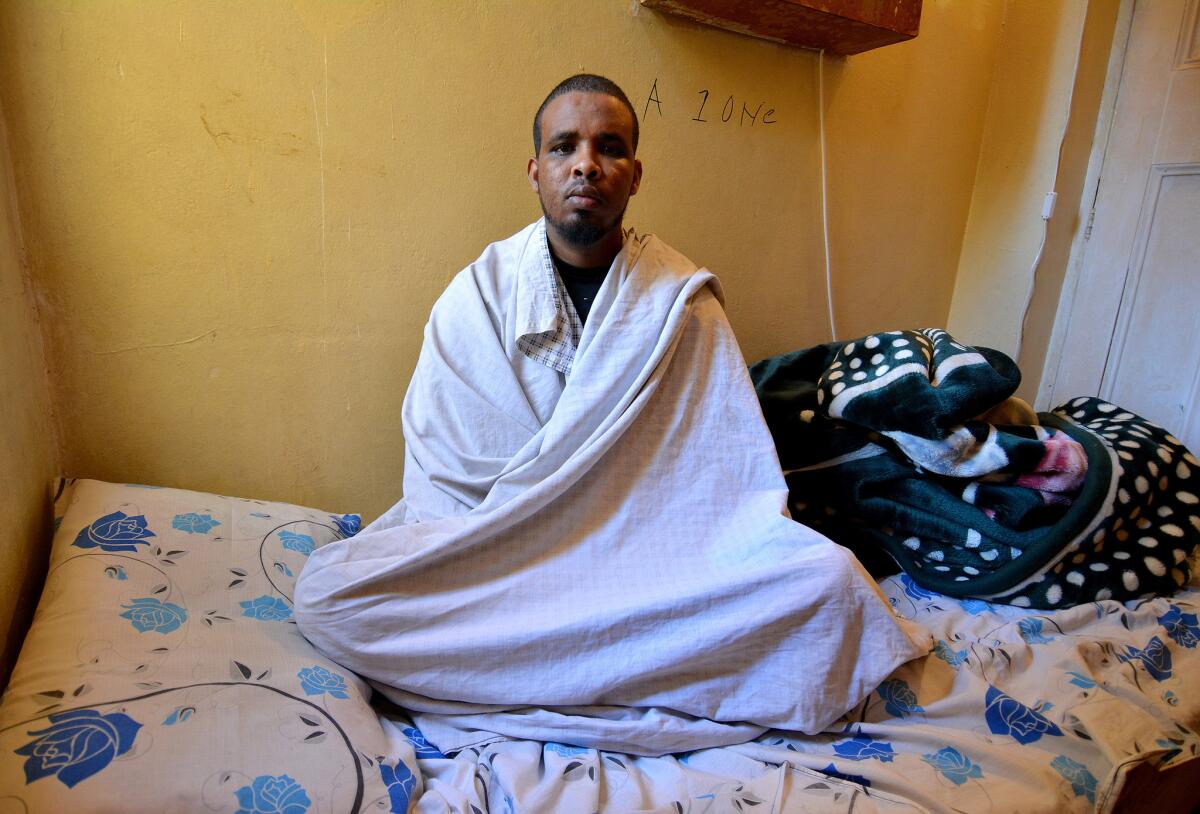 Ahmed Hashe, 28, recovering in a Somali boarding house in Pretoria, South Africa, after he was stabbed, beaten and left for dead by a mob. He fled war and chaos in his homeland Somalia seven years ago, for peace in South Africa.