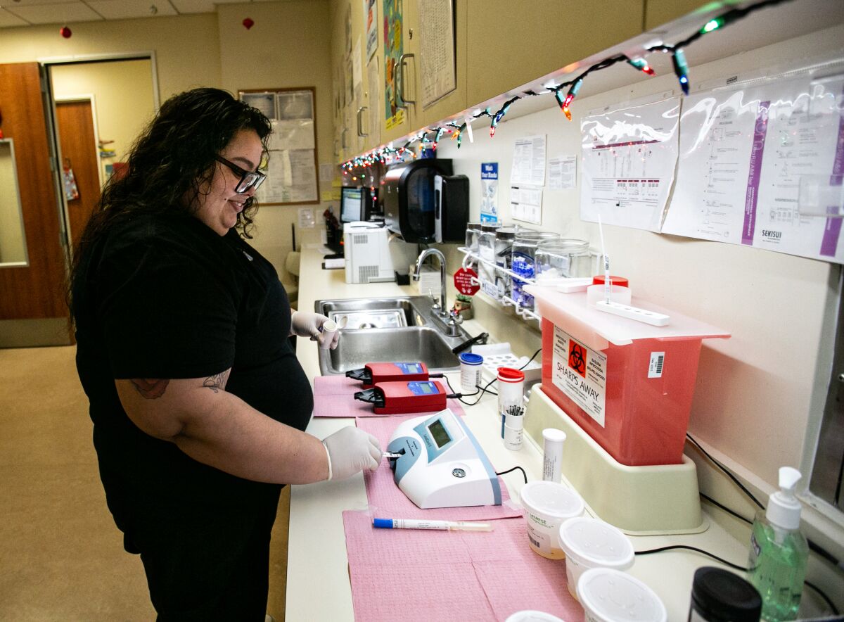 Karen Mendez tests blood from a patient at a South L.A. clinic.