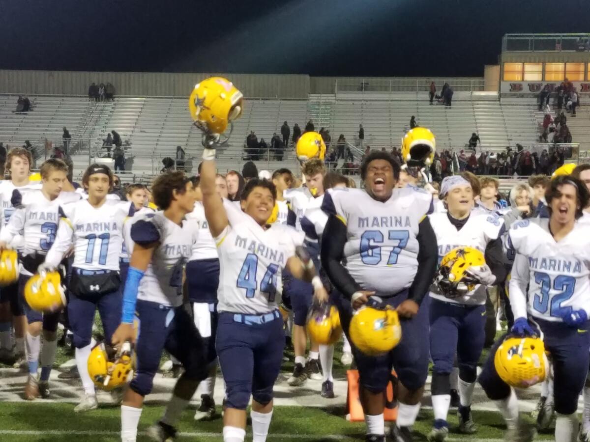 Marina players celebrate a 27-7 victory at Hemet in the semifinals of the CIF Southern Section Division 11 playoffs on Friday.