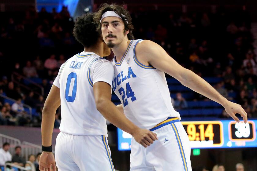 LOS ANGELES, CALIF. - DEC. 21, 2022. UCLA Bruins guard Jaime Jaquez Jr. is copngratulated by teammate Jaylen Clark after scoring a basket and getting fouled by UC Davis in the second half on Wednesday, Dec. 21, 2022. (Luis Sinco / Los Angeles Times)