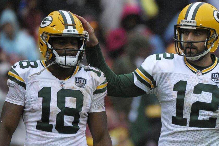 Green Bay Packers quarterback Aaron Rodgers (right) and wide receiver Randall Cobb (left) celebrate a touchdown during an NFL football game against the Washington Redskins, Sunday, Sept. 23, 2018, in Landover, Md. (AP Photo/Mark Tenally)