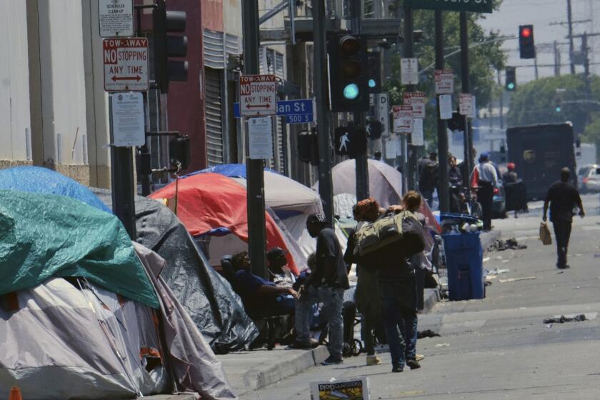 FILE - In this May 30, 2019 file photo tents housing homeless line a street in downtown Los Angeles. The number of homeless people counted across Los Angeles County jumped 12% over the past year to a total of 58,936. The Los Angeles Homeless Services Authority presented the results of January's annual count to the Board of Supervisors on Tuesday, June 4. (AP Photo/Richard Vogel,File)