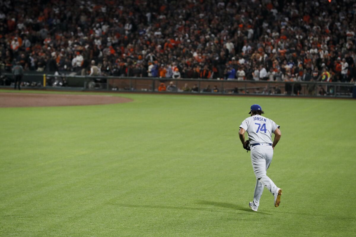 Dodgers relief pitcher Kenley Jansen runs out of the bullpen to take the mound in the eighth inning of Game 5.