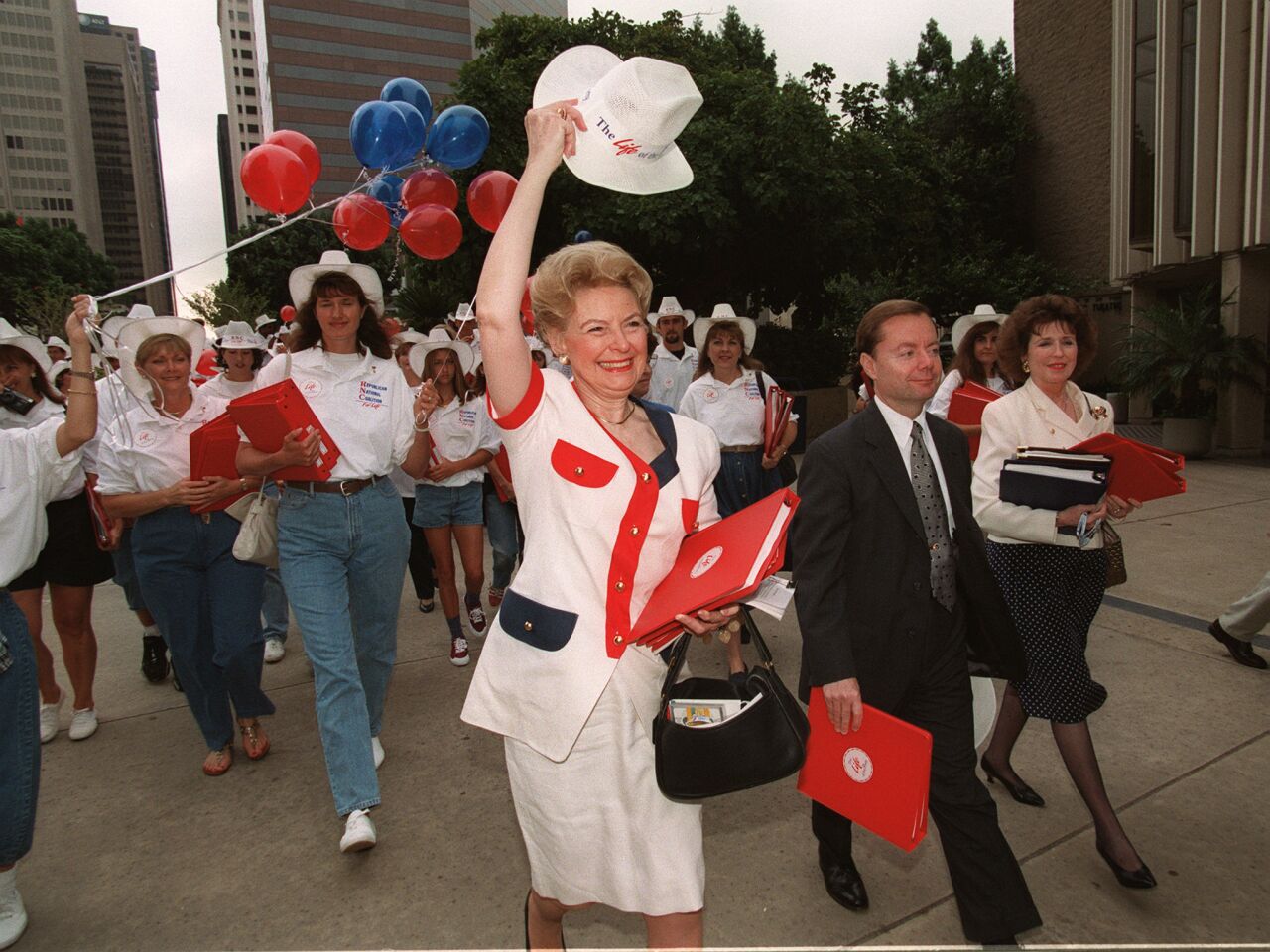 Republican National Coalition for Life Chairwoman Phyllis Schlafly waves her hat as she leads her group to the Republican platform hearing in San Diego in 1996.