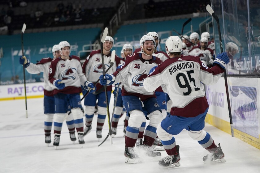 Colorado Avalanche left wing Andre Burakovsky (95) celebrates with teammates after scoring during overtime of an NHL hockey game against the San Jose Sharks in San Jose, Calif., Monday, May 3, 2021. The Avalanche won, 5-4. (AP Photo/Jeff Chiu)