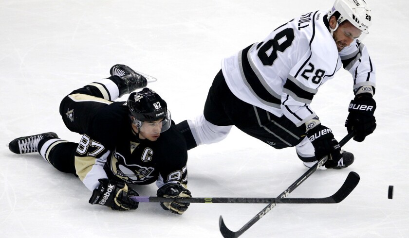 Kings center Jarret Stoll collides with Penguins center Sidney Crosby as they battle for possession of the puck.