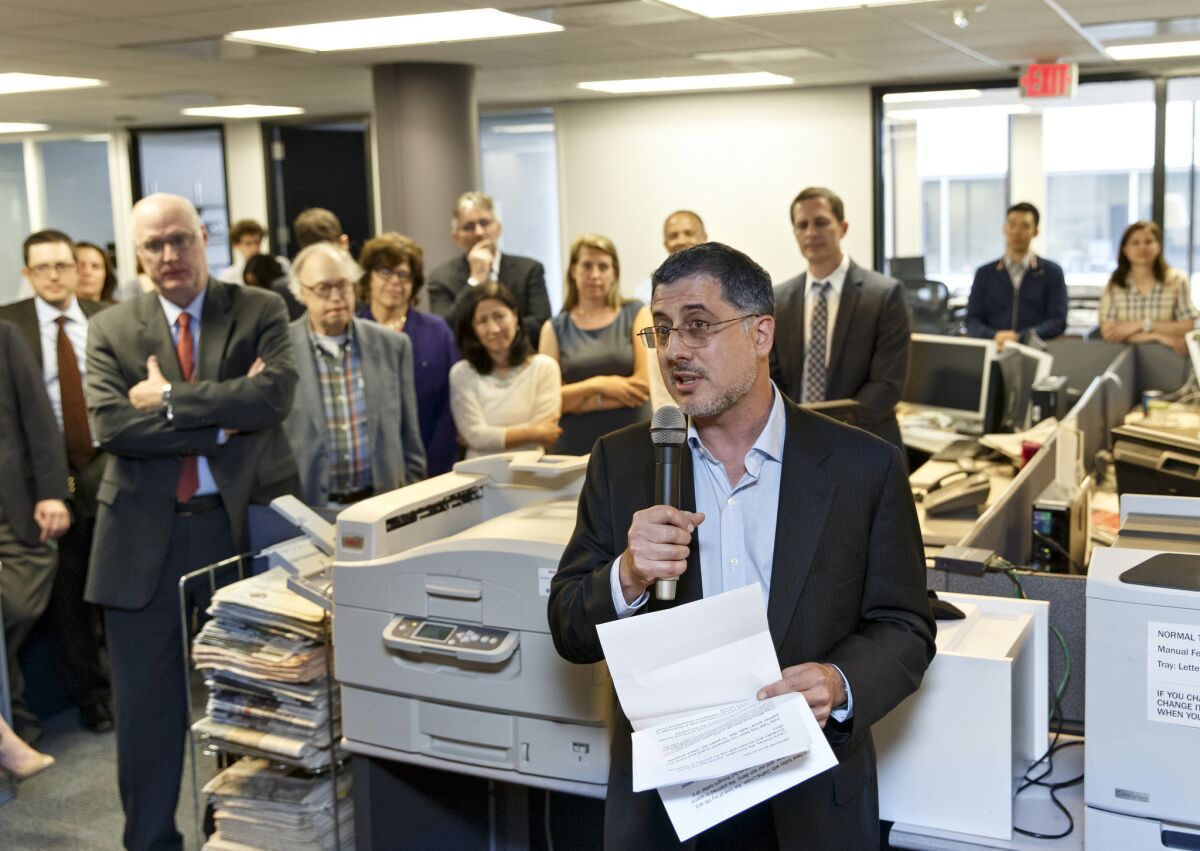 The Washington Post and the Guardian won Pulitzer Prizes for public service Monday for articles revealing the scope of surveillance by the National Security Agency. Above, writer Barton Gellman speaking in the Post's newsroom about the series after the prizes were announced.