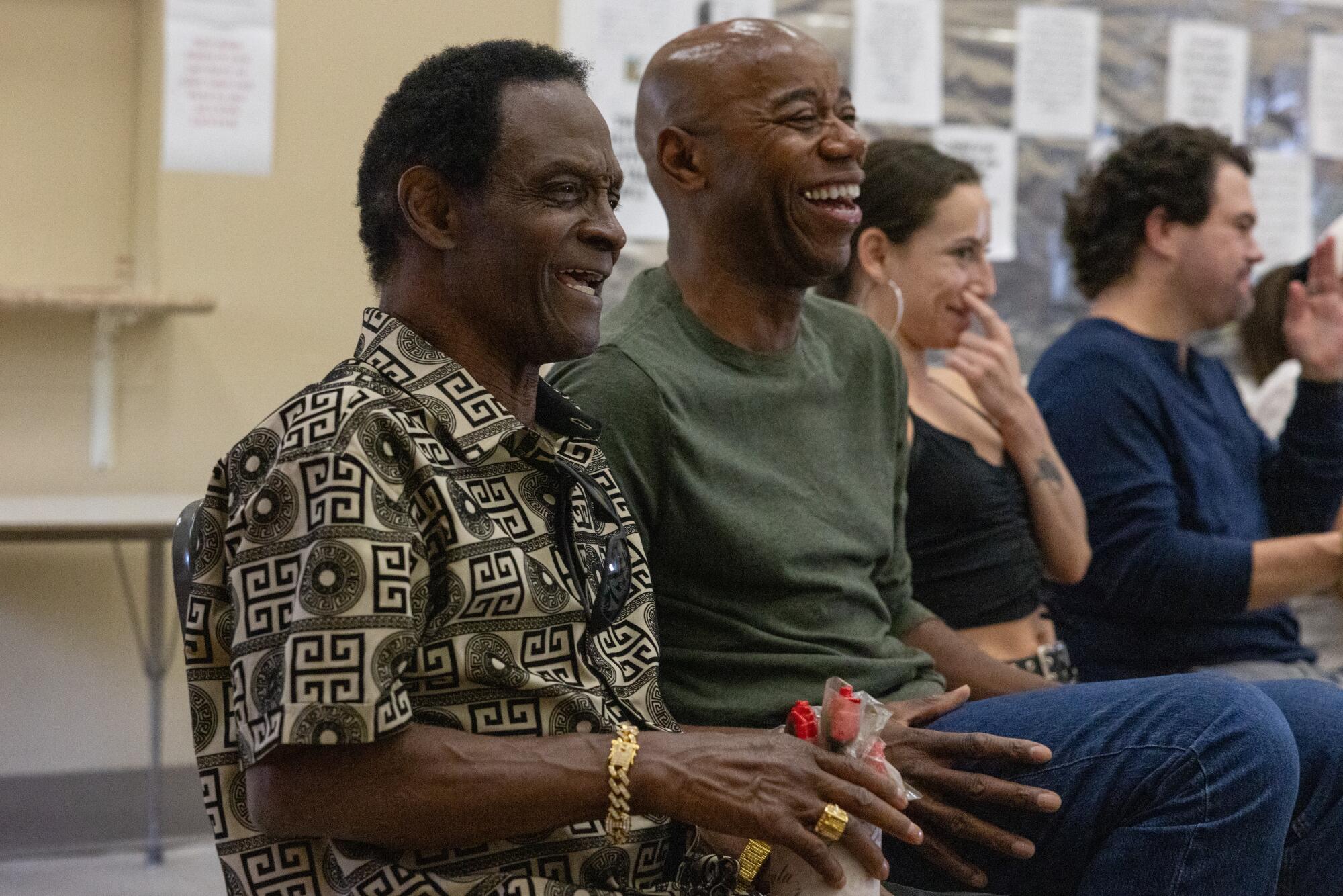 People smile while seated.