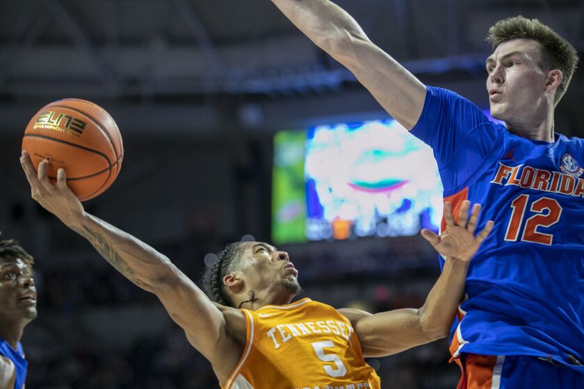 Tennessee guard Zakai Zeigler (5) drives under pressure from Florida forward Colin Castleton (12) during the first half of an NCAA college basketball game, Wednesday, Feb. 1, 2023, in Gainesville, Fla. (AP Photo/Alan Youngblood)