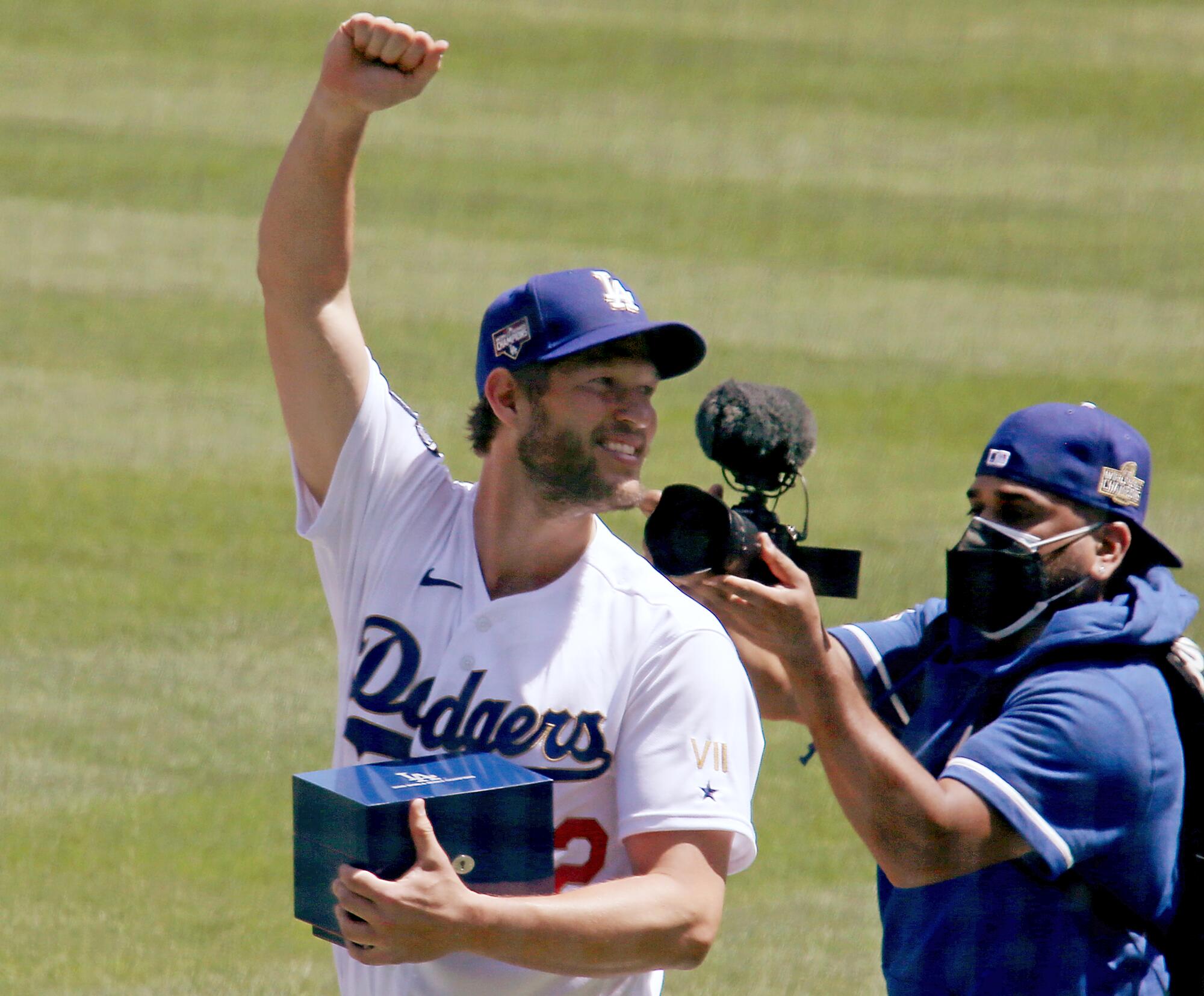 Dodgers pitcher Clayton Kershaw celebrates after getting his championship ring during a ceremomy.