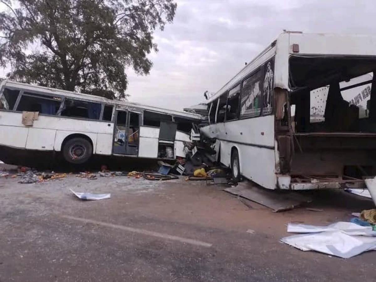 Two damaged buses are pictured after they collided on a road in Gniby, Senegal, Sunday Jan. 8, 2023. At least 40 people were killed and dozens injured in this bus crash in central Senegal, the country's president Macky Sall said Sunday. (Elimane Fall via AP)