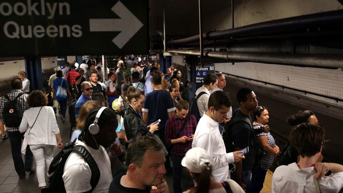 Passengers wait for the A train, the line that was most affected by the recent derailment.