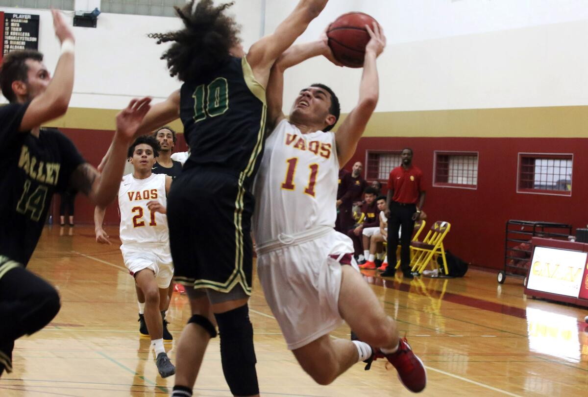 Glendale Community College men's basketball player Andreyas Boghossian attempts to go up for a shot during Saturday's game against visiting L.A. Valley College.