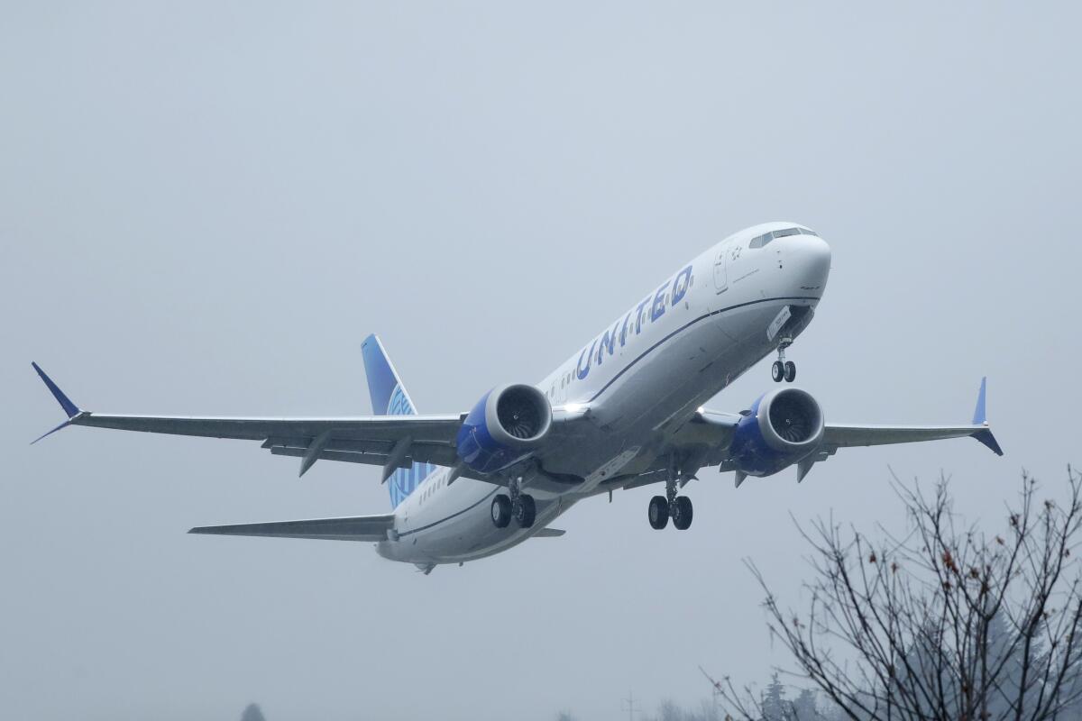A Boeing 737 Max airplane takes off in the rain