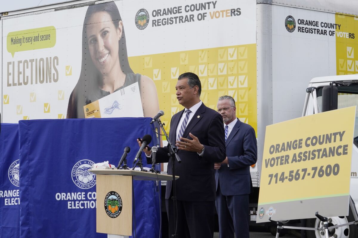 California Secretary of State Alex Padilla, left, and Orange County Registrar of Voters Neal Kelley hold a news conference