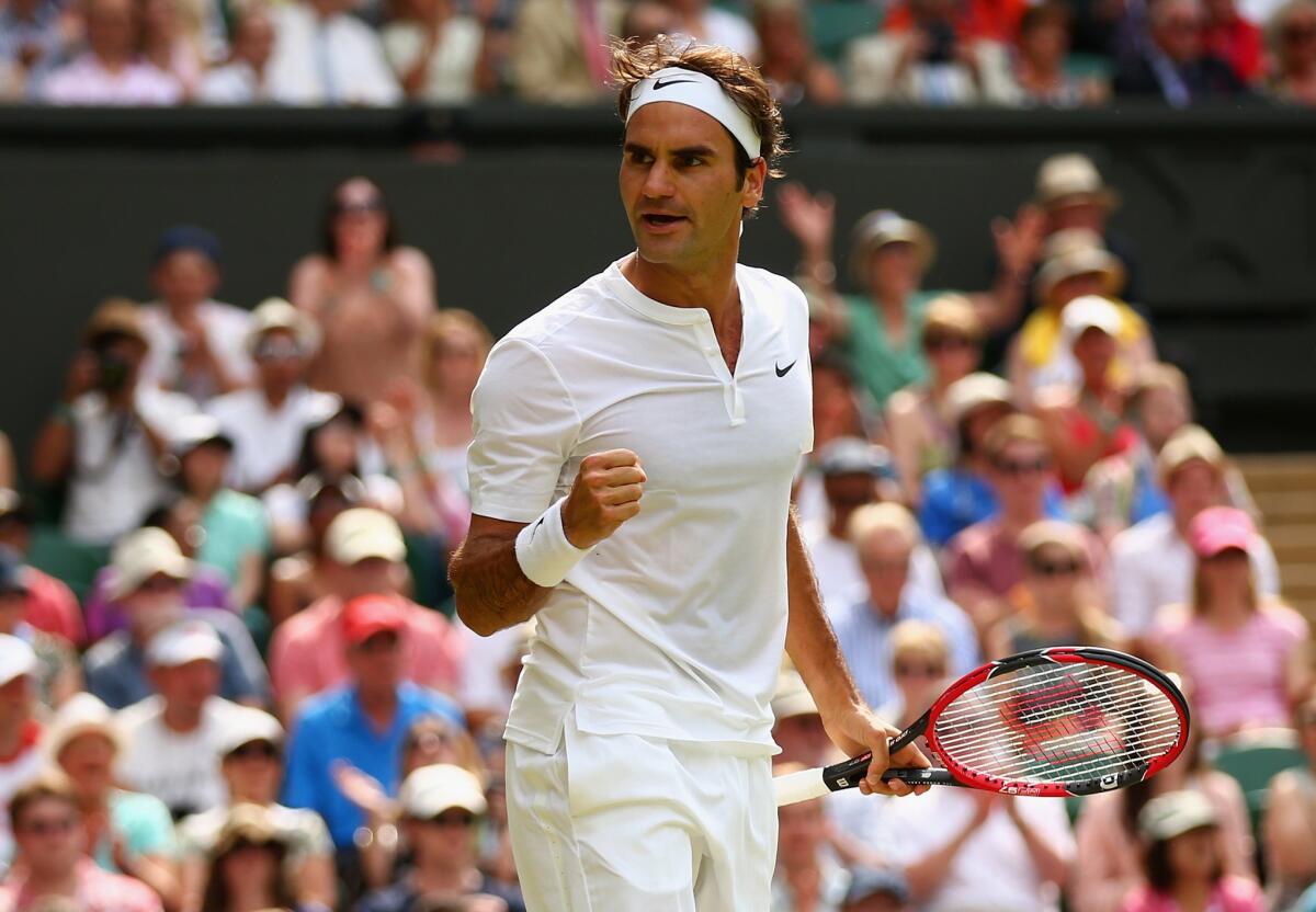 Roger Federer reacts after winning a point against Sam Querrey during their second-round match at Wimbledon on Thursday.