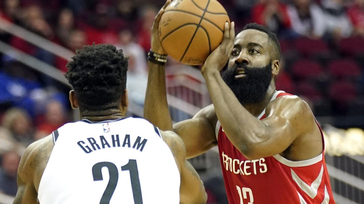 Houston Rockets' James Harden shoots over Treveon Graham.