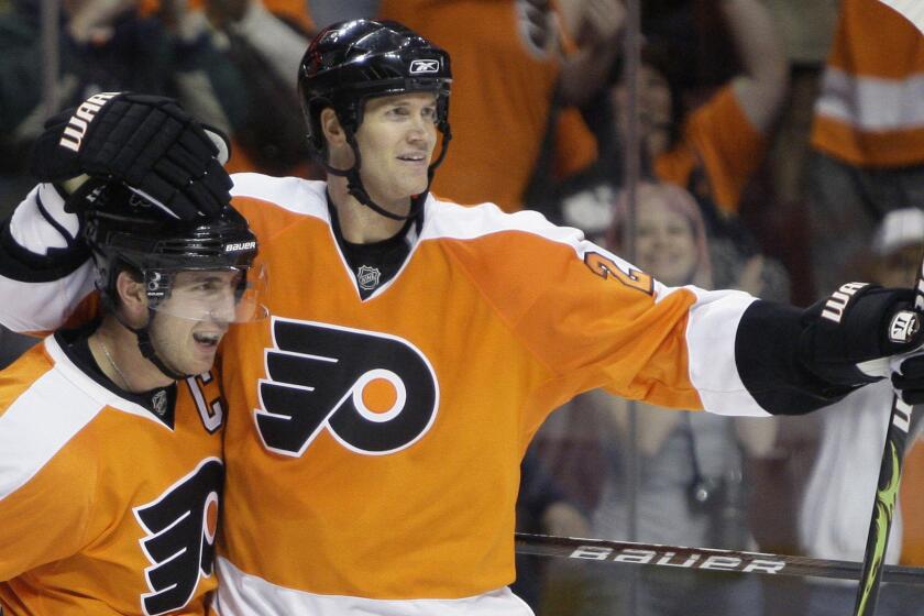 Philadelphia Flyers defenseman Chris Pronger, right, celebrates a goal scored by teammate Mike Richards, left, during a game against the Washington Capitals in 2009.