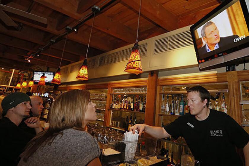 Patrons in Park City, Utah, watch Lance Armstrong's interview with Oprah Winfrey.