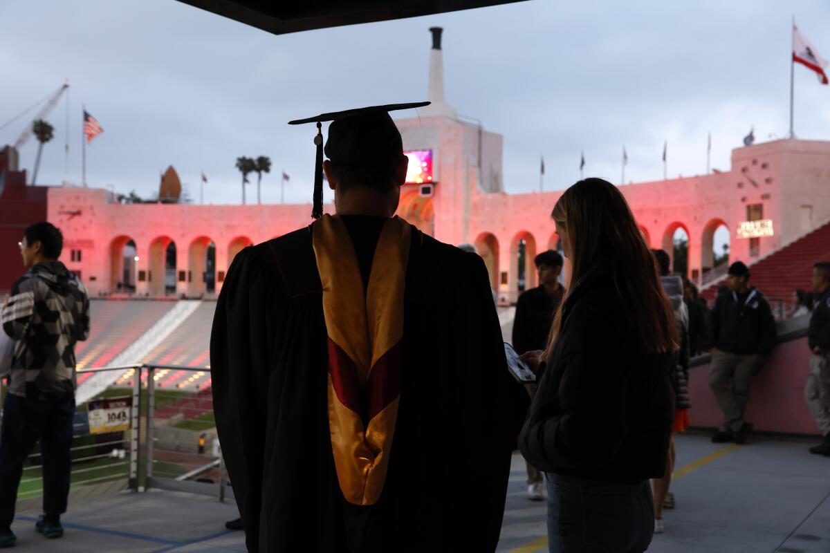 Chase Block wears his cap and gown during the "Trojan Family Graduate Celebration" on May 9, at The Coliseum on May 9.