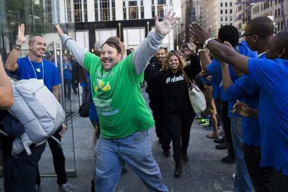 Greg Packer, 49, celebrates the fact that he gets to enter the Apple store on Fifth Avenue in Manhattan, on his way to purchase an iPhone5.