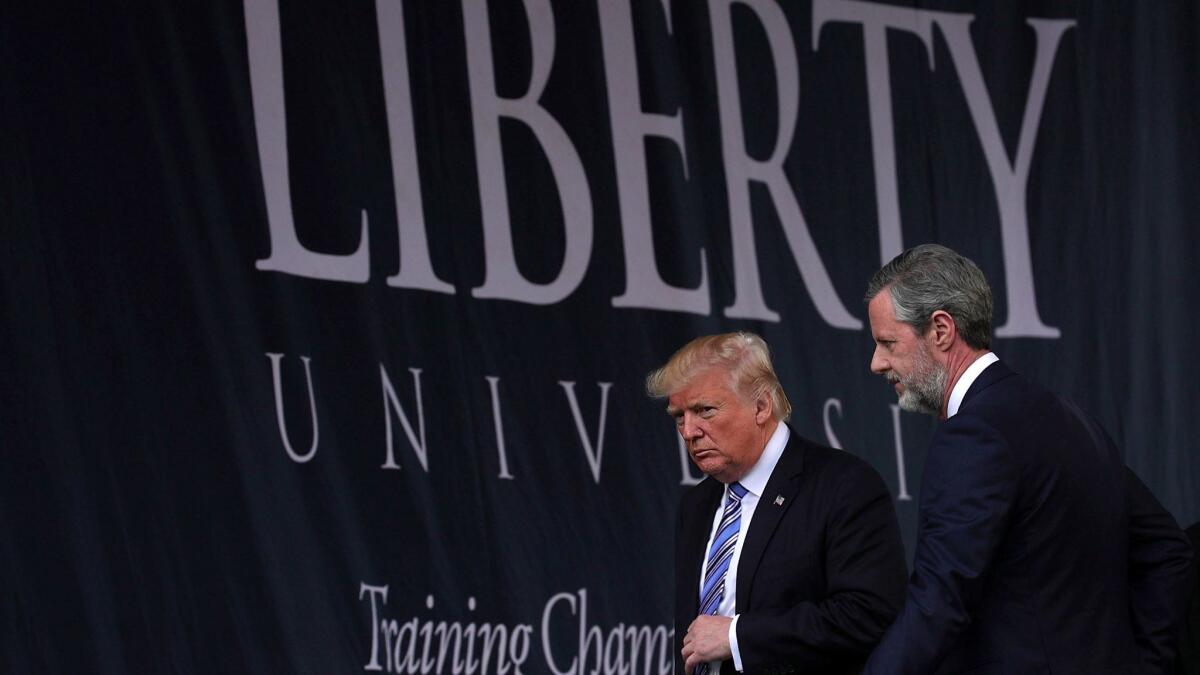 Accompanied by Jerry Falwell Jr., President Trump leaves after delivering the keynote address at the evangelical Christian Liberty University on May 13.