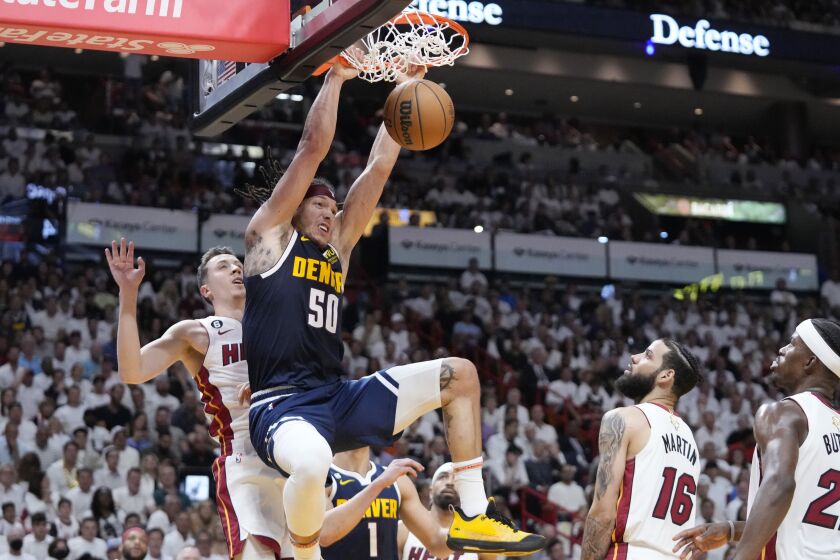Denver Nuggets forward Aaron Gordon (50)dunks the ball during the first half of Game 4 of the basketball NBA Finals against the Miami Heat, Friday, June 9, 2023, in Miami. (AP Photo/Wilfredo Lee)