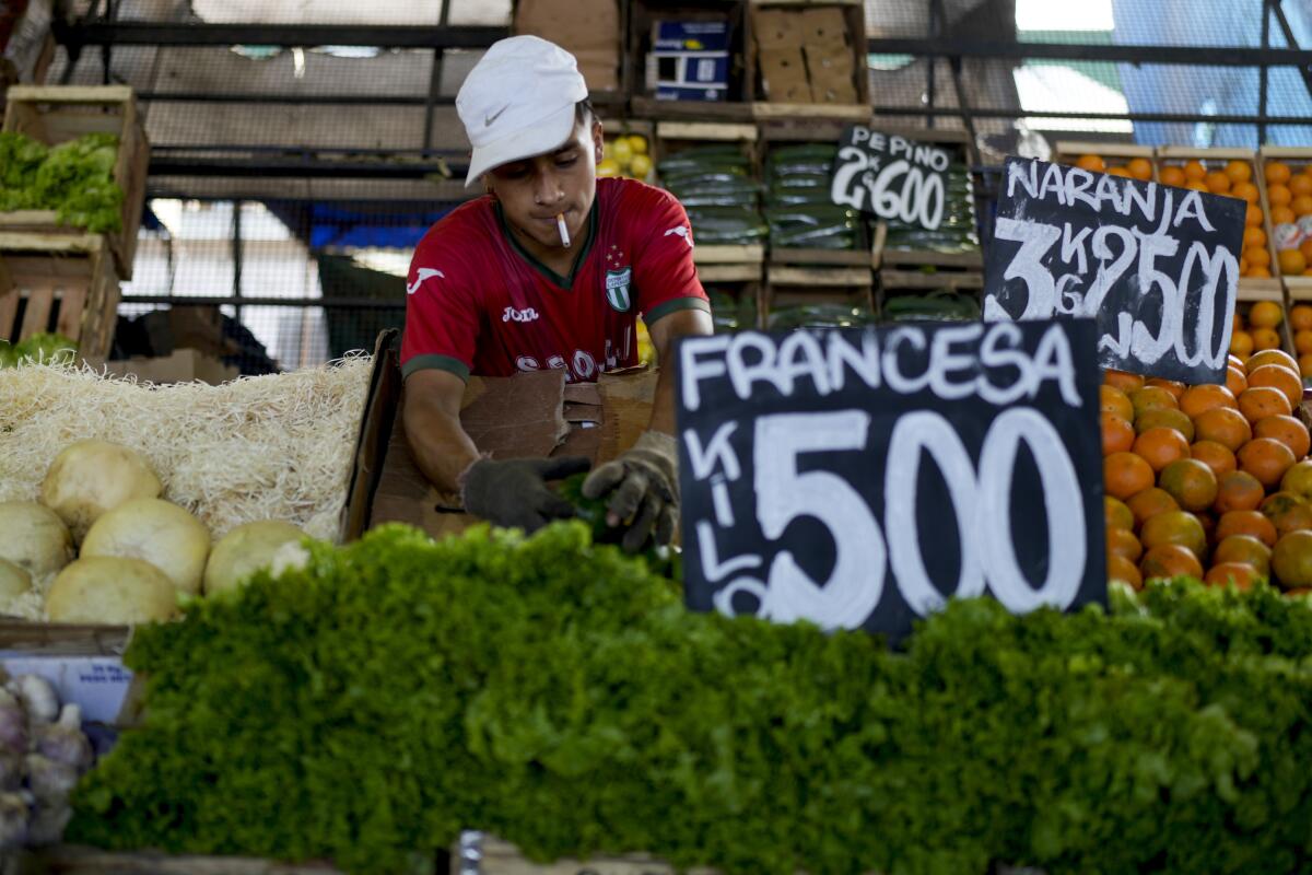 A vendor at a vegetable market on the outskirts of Buenos Aires