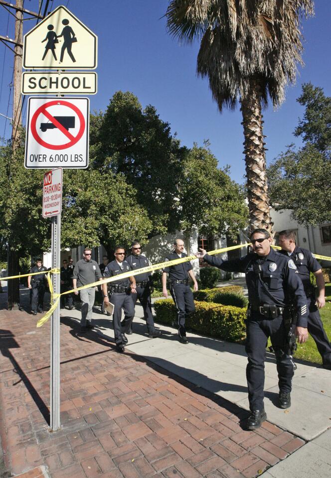 Glendale Police officers leave R.D White Elementary School after searching the school due a bomb threat on Monday, January 7, 2013.
