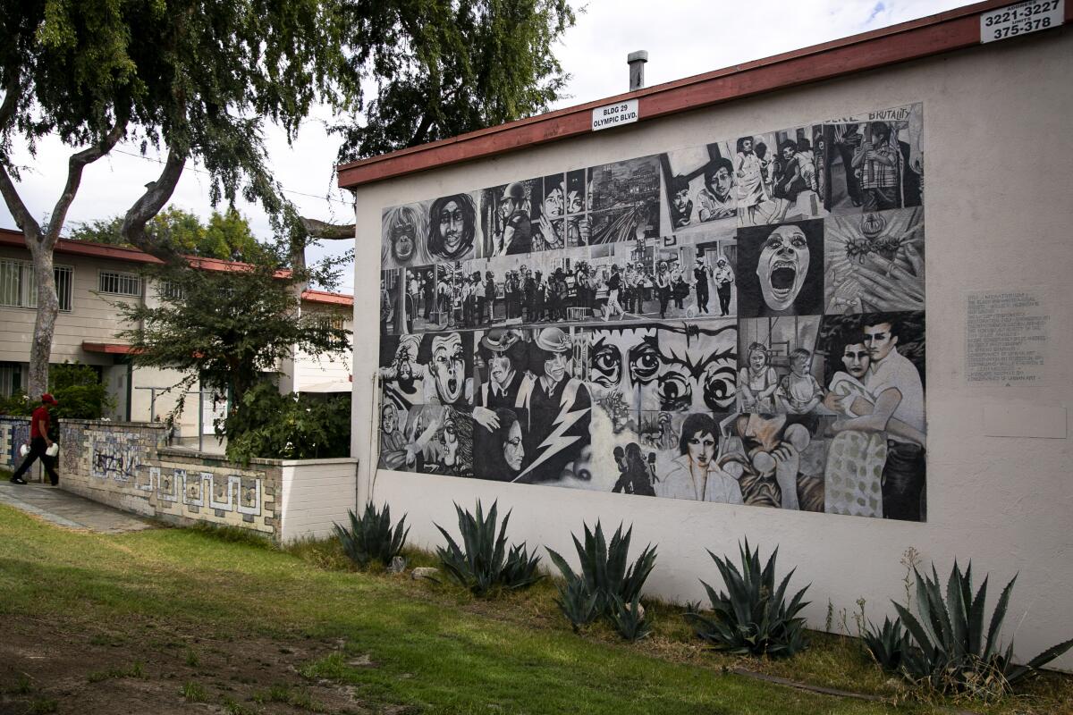 A mural painted with black and white paint is inspired by the cellular nature of film, showing a variety of scenes.