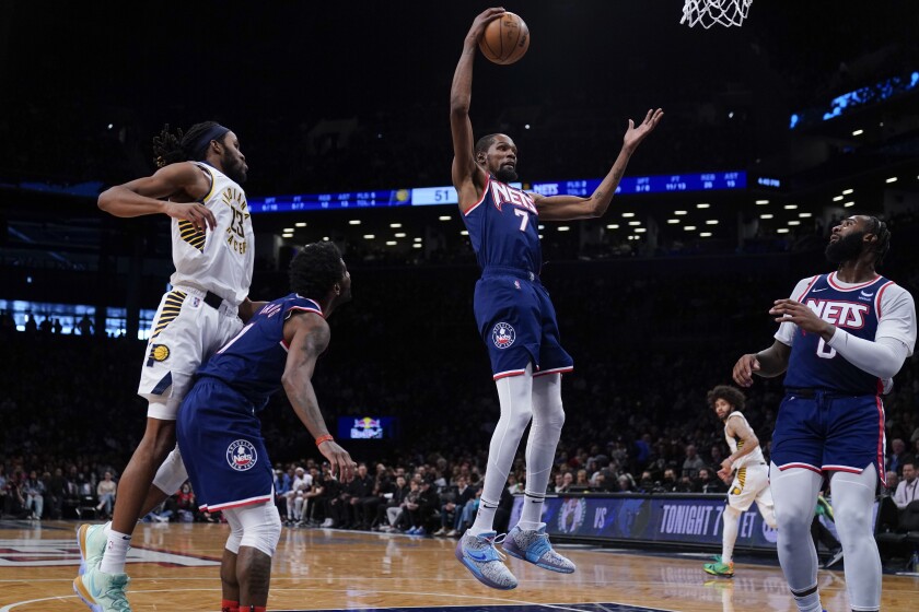 Brooklyn Nets' Kevin Durant, center, grabs a rebound during the first half of an NBA basketball game against the Indiana Pacers at the Barclays Center, Sunday, Apr. 10, 2022, in New York. (AP Photo/Seth Wenig)