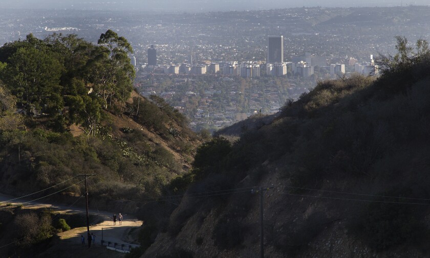 Hikers walk along a dirt trail in Runyon Canyon Park in the fall. A proposal to build a basektball court in the park has raised objections among some park users and nearby residents.