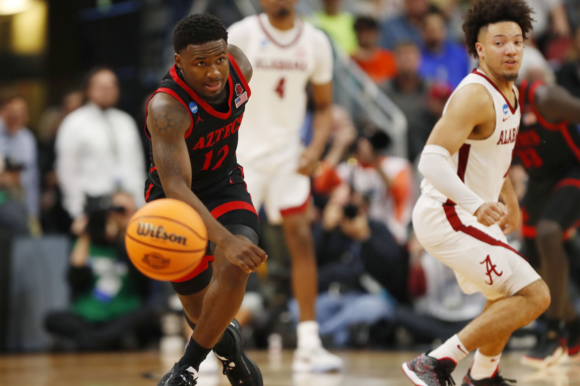 Aztecs guard Darrion Trammell steals the ball from Alabama's Mark Sears in an NCAA Tournament game Friday in Louisville, Ky.