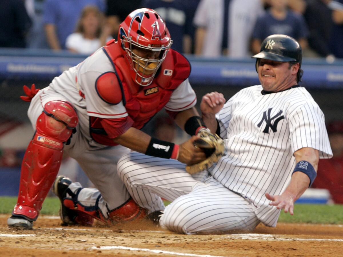 Angels catcher Jose Molina, left, tags out the Yankees' Jason Giambi during a game at Yankee Stadium in August 2006.