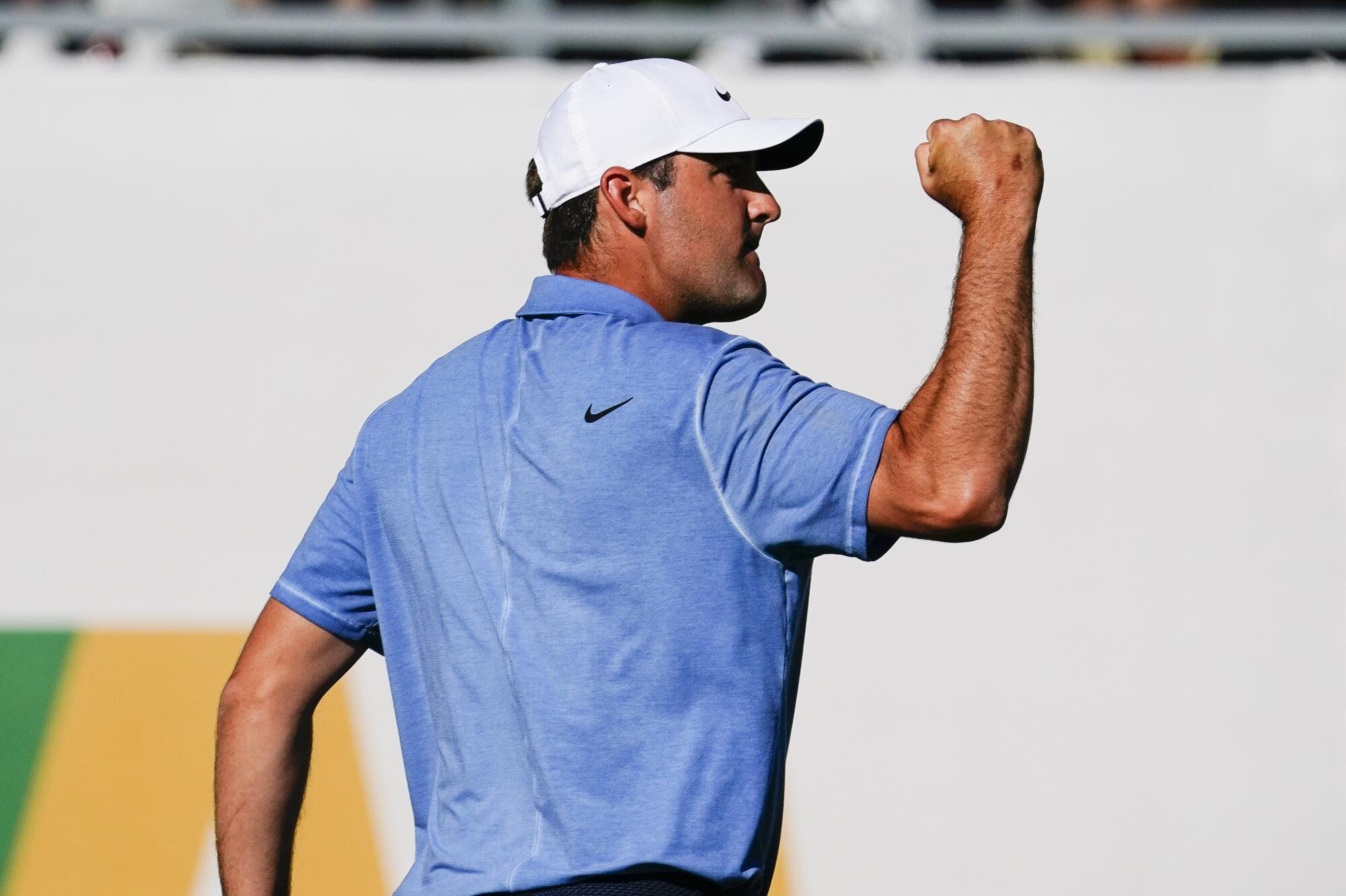 Scottie Scheffler pumps his fist after making par on the 16th hole of the final round at the Phoenix Open.