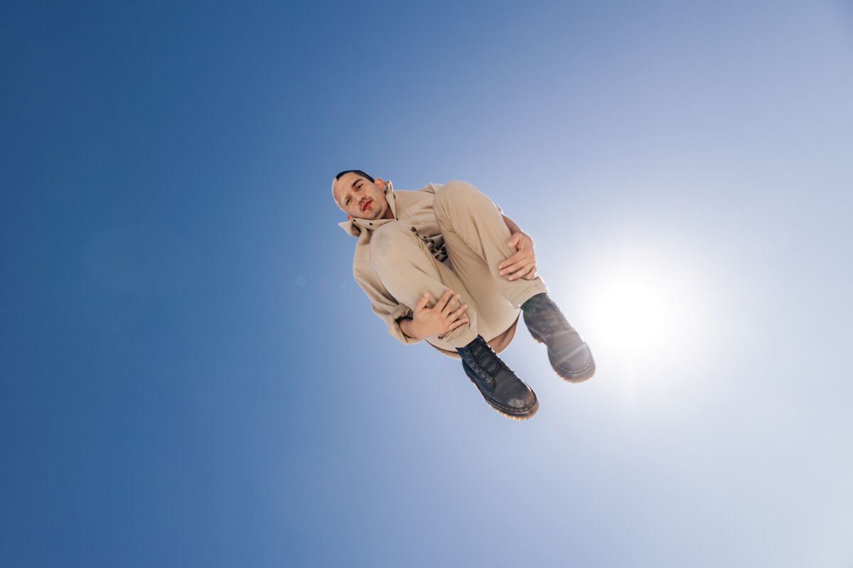 A man jumps in the air from a trampoline.