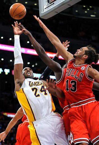 Lakers guard Kobe Bryant has his final driving shot of the game blocked by Bulls forward Luol Deng (center, hidden) as center Joakim Noah also takes a swipe at the ball as time expires Sunday at Staples Center.