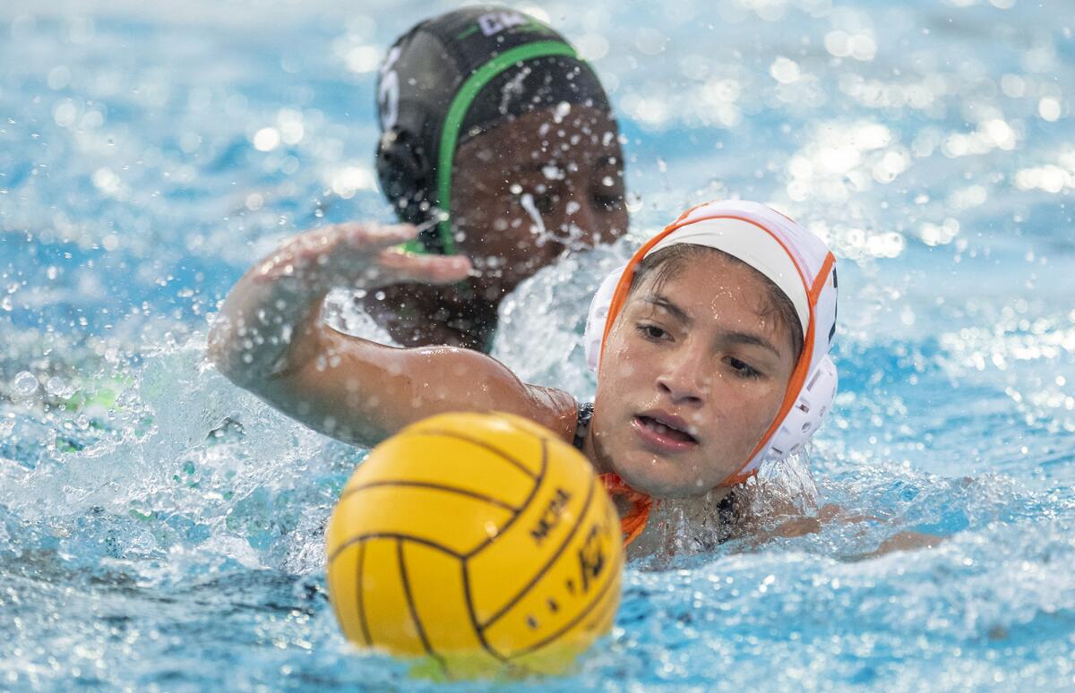 Los Amigos' Jade Tirado beats Costa Mesa's Sey Currie to the ball in the first round of the CIF Southern Section Division 5 playoffs on Tuesday.