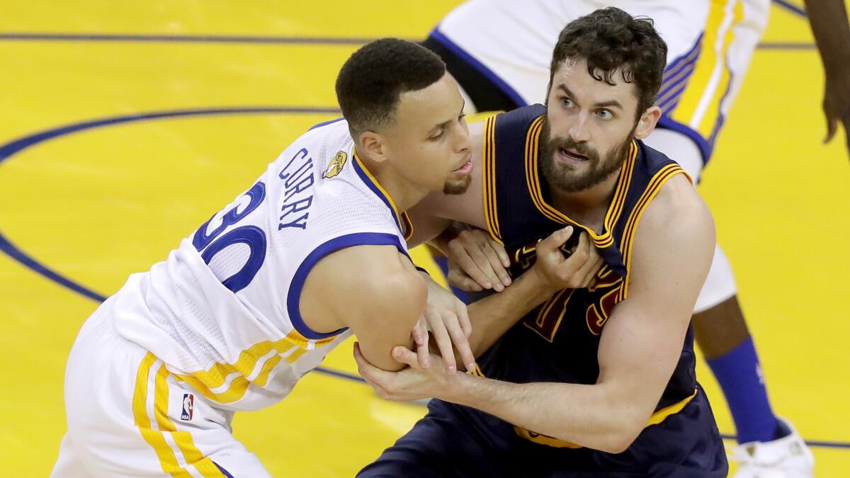 Kevin Love, right, battles for position with Stephen Curry during Game 1.
