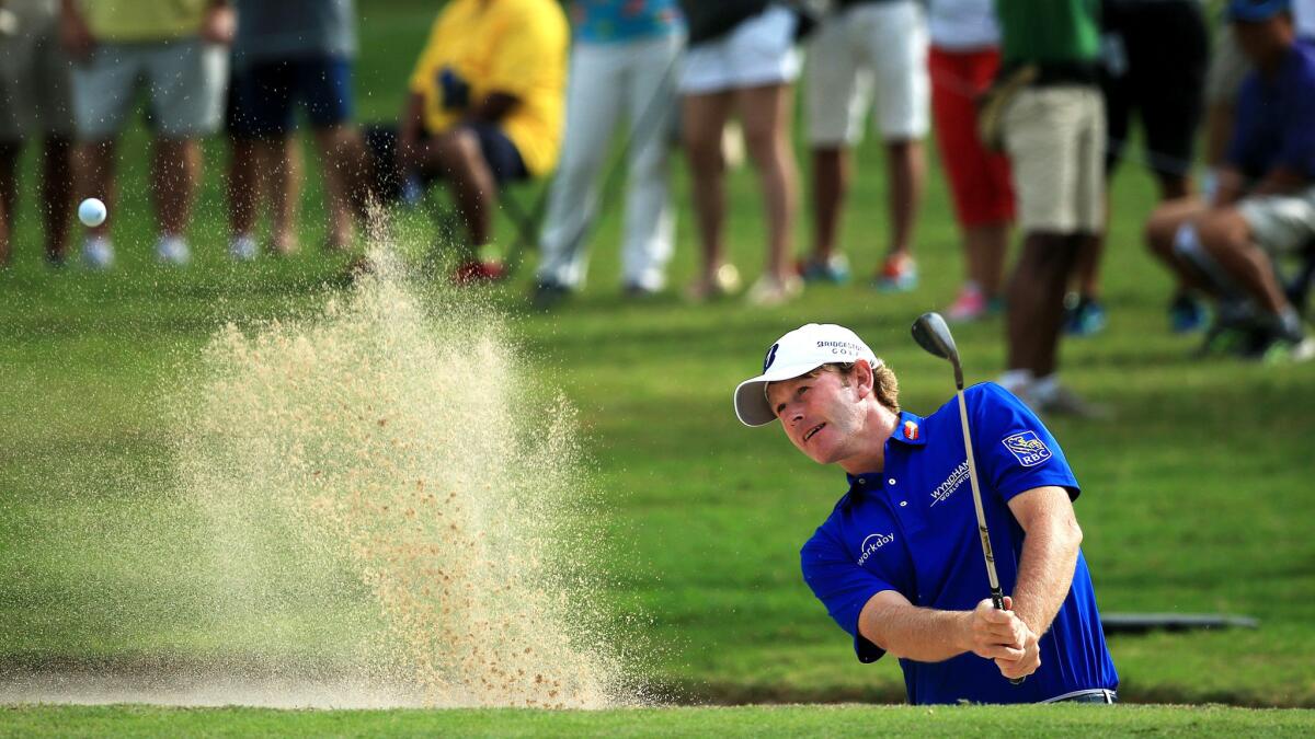 Brandt Snedeker hits out of a greenside bunker at No. 18 during the second round of the Sony Open on Friday.