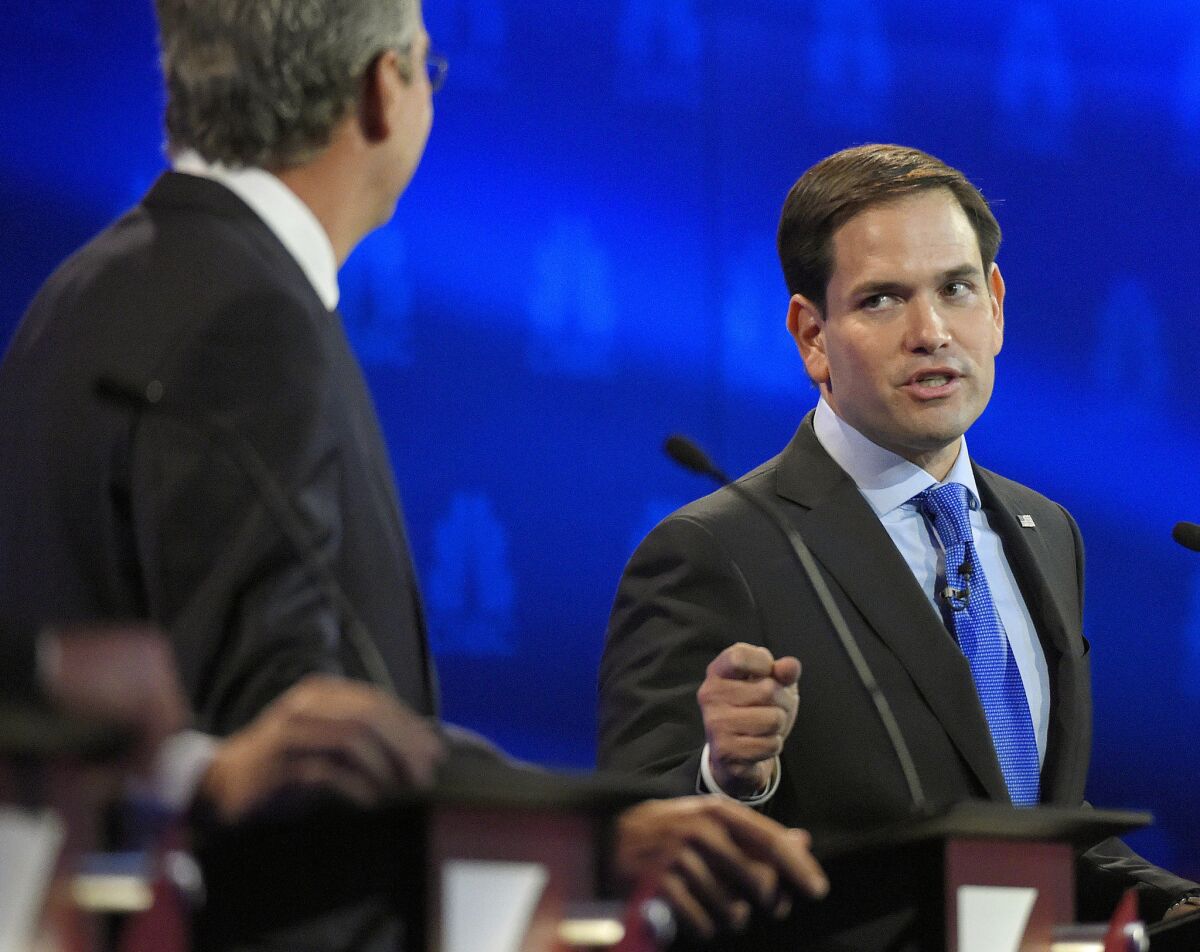 Marco Rubio, right, and Jeb Bush, argue a point during the Republican presidential debate at the University of Colorado on Oct. 28, 2015, in Boulder.